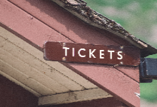old wood building with tickets sign