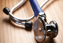 stethoscope on wood desk