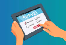 person holding a tablet with a survey page pulled up