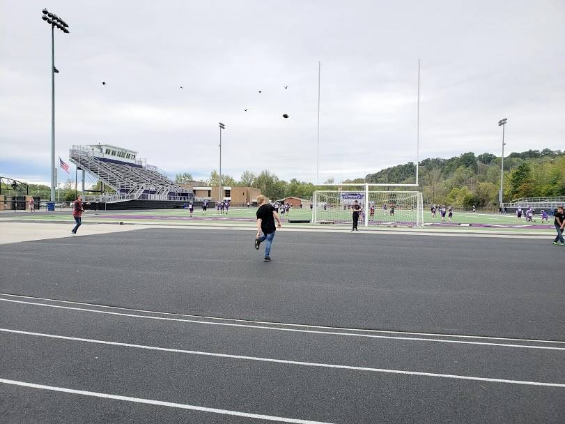 Students Passing Football