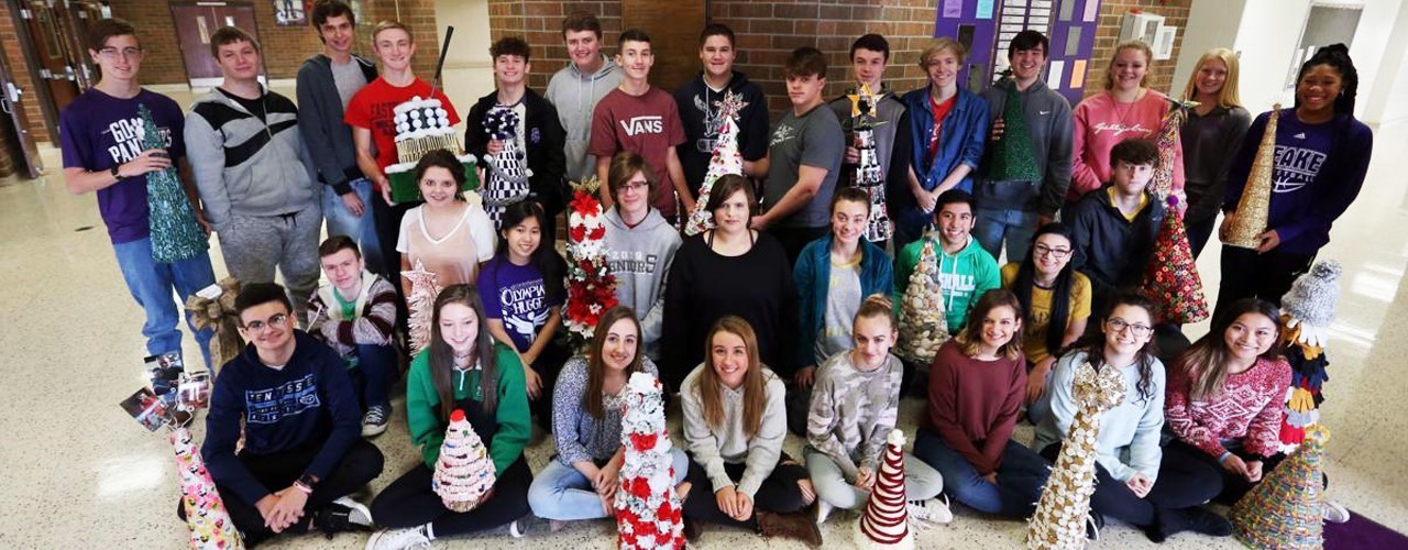 Groupd of students displaying various Christmas trees