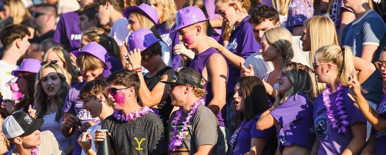 student section at football game wearing purple 